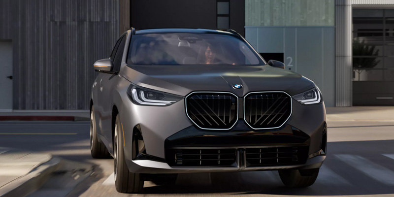 Gray BMW SUV driving in an urban setting.